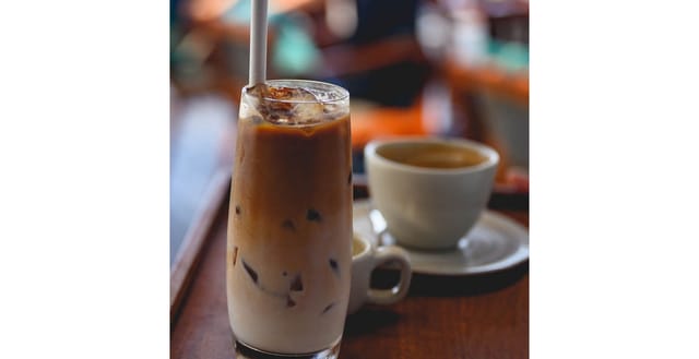 An iced latte beside an espresso